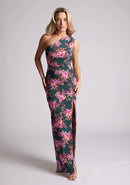 Front image of a model wearing a green floral maxi dress with a  asymmetric one-shoulder design, delicate pleats and front skirt split. The design featured is the Vesper Charlotte Green Floral Maxi Dress