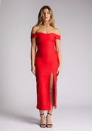 Front image of a model wearing a red midaxi dress, featuring a bardot neckline with subtle sweetheart detail, off shoulder style bands and a front skirt split. The style featured is Vesper Clara Red Midaxi Dress.