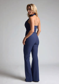 Back quarterimage of a model wearing navy wide leg trousers with a flattering high waist and wide leg design. The design featured is the Vesper Connie Navy Wide Leg Trousers paired with Vesper Eve Navy Waistcoat