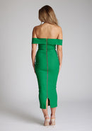 Back image of a model wearing a emerald green midaxi dress with a off-shoulder bardot neckline, with arm bands v-shaped cut-out at neckline and keyhole cut-out under bust and bodycon style dress with a statement gold zip at centre back. The design featured is the Vesper Daphne Emerald Green Midaxi Dress