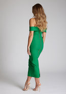 Back quarter image of a model wearing a emerald green midaxi dress with a off-shoulder bardot neckline, with arm bands v-shaped cut-out at neckline and keyhole cut-out under bust and bodycon style dress with a statement gold zip at centre back. The design featured is the Vesper Daphne Emerald Green Midaxi Dress