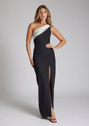 Front image of a brunette model wearing a monochrome dress in a maxi length with a one shoulder 
Front image of a brunette model wearing a monochrome dress in a maxi length with a asymmetric neckline, an ivory satin band across the neckline, thigh-high leg split and figure-hugging stretch crepe fabric with a white band across neckline. The design featured is the Vesper Fliss Monochrome Maxi Dress