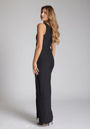 Back quarter image of a brunette model 
 wearing a monochrome dress in a maxi length with a asymmetric neckline, an ivory satin band across the neckline, thigh-high leg split and figure-hugging stretch crepe fabric with a white band across neckline. The design featured is the Vesper Fliss Monochrome Maxi Dress