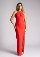 Front image of a model wearing a red halter neck maxi dress, featuring a keyhole cut out and a front skirt split. The dress featured is the Vesper Ivie red maxi dress
