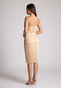 Back quarter image of the model wearing a champagne satin midi dress with a mesmerising cowl neckline with delicate thin straps made from high-shine allure satin. The design featured is the Vesper Lisa Champagne Satin Midi Dress