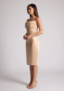 Front quarter image of the model wearing a champagne satin midi dress with a mesmerising cowl neckline with delicate thin straps made from high-shine allure satin. The design featured is the Vesper Lisa Champagne Satin Midi Dress