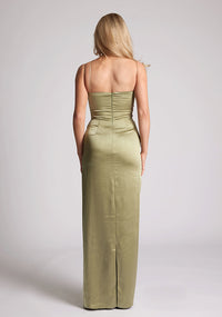 Back image of a model wearing an Olive Green Maxi Dress with a scoop neckline, thin straps, an asymmetric strap detail, subtle pleat detail at side of hip. The&nbsp; dress featured is Vesper Lorah Olive Maxi Dress.