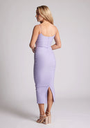 Back quarter image of a model wearing an orange midaxi dress with a scoop neckline with thin straps, a bodycon fit and invisible centre back zip. The dress featured is the Vesper Maddie Lilac Midaxi Dress