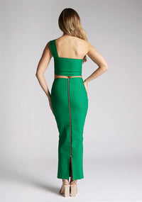Back image of a blonde model wearing a emerald one shoulder top with a one-shoulder cut and straight neckline, side pleating and a size zip. The design featured is the Vesper Matilda Emerald One Shoulder Top pair with Vesper Hana Emerald Skirt