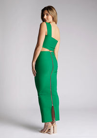 Back quarter image of a blonde model wearing a emerald one shoulder top with a one-shoulder cut and straight neckline, side pleating and a size zip. The design featured is the Vesper Matilda Emerald One Shoulder Top pair with Vesper Hana Emerald Skirt