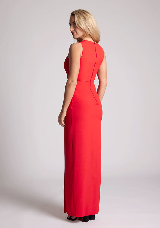 Back quarter image of a model wearing a Red Asymmetrical Detail Maxi Dress with a bold asymmetric neckline, front leg split and centre back zip fastening. The design features Vesper Polly Red Asymmetrical Maxi Dress