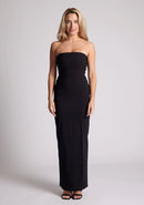 Front image of a model wearing a black maxi dress with a straight strapless neckline, body-hugging silhouette, front skirt split and invisible centre back zip. The design featured is the Vesper Raine Black Strapless Maxi Dress