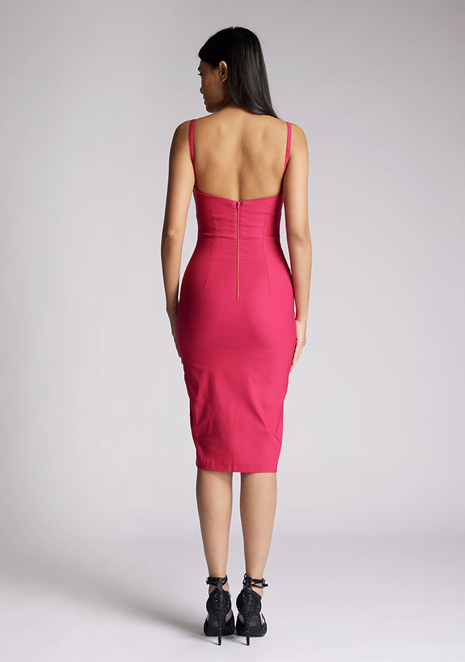Back image of a model wearing a cerise midi dress with a chic square neckline and slender straps, exuding sophistication and grace. The design featured is the Vesper Raye Cerise Midi Dress
