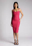 Front image of a model wearing a cerise midi dress with a chic square neckline and slender straps, exuding sophistication and grace. The design featured is the Vesper Raye Cerise Midi Dress
