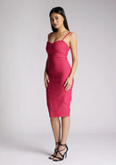 Front quarter image of a model wearing a cerise midi dress with a chic square neckline and slender straps, exuding sophistication and grace. The design featured is the Vesper Raye Cerise Midi Dress