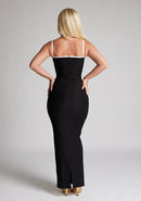 Back image of a  model wearing a monochrome maxi dress with a square neckline with thin straps and a bodycon fit. The design featured is the Vesper Sienna Monochrome Bodycon Maxi Dress