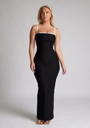 Front image of a  model wearing a monochrome maxi dress with a square neckline with thin straps and a bodycon fit. The design featured is the Vesper Sienna Monochrome Bodycon Maxi Dress