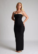 Front quarter image of a  model wearing a monochrome maxi dress with a square neckline with thin straps and a bodycon fit. The design featured is the Vesper Sienna Monochrome Bodycon Maxi Dress