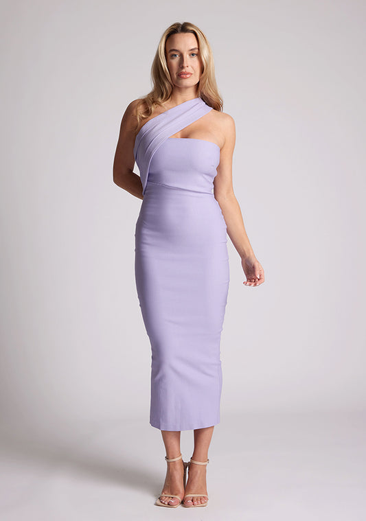 Front image of blonde model wearing lilac one shoulder midaxi dress with a unique one-sleeve design, asymmetric cut neckline, bycon fit, back zip and closure short split. The design featured is the Vesper Teo Lilac One Shoulder Midaxi Dress