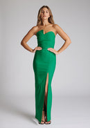 Front image of a blonde model wearing an Emerald Green Maxi Dress with a slim-fit, sleeveless, and a front skirt split the design features the Vesper Thyme Emerald Green Maxi Dress