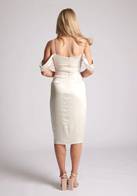 Back image of model wearing a cream satin bardot midi dress with a  delicate allure satin, cowl neckline and invisible back zip with thin straps and draped arm bands.  The design featured is the Vesper Victoria Cream Satin Bardot Midi Dress