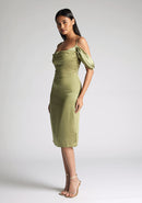 Front quarter image of model wearing a olive satin bardot midi dress with a  delicate allure satin, cowl neckline and invisible back zip with thin straps and draped arm bands.  The design featured is the Vesper Victoria Olive Satin Bardot Midi Dress