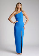Front image of a model wearing a cobalt blue maxi dress with a asymmetric neckline, one shoulder strap, front skirt split and open back with asymmetric strap across back. The design featured is the Vesper Viva Cobalt One Shoulder Maxi Dress.
