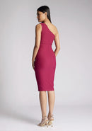 Back quarter image of model wearing a berry midi dress with an alluring one-sleeve design and a captivating asymmetric cut, and a discreet back zip. The design featured is the Vesper Xyla Berry One Shoulder Midi Dress