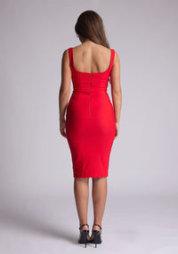Back image of model wearing a red pencil dress with a square-cut neckline and straps and a bodycon fit. The design features is the Vesper Zada Red Bodycon Pencil Midi Dress