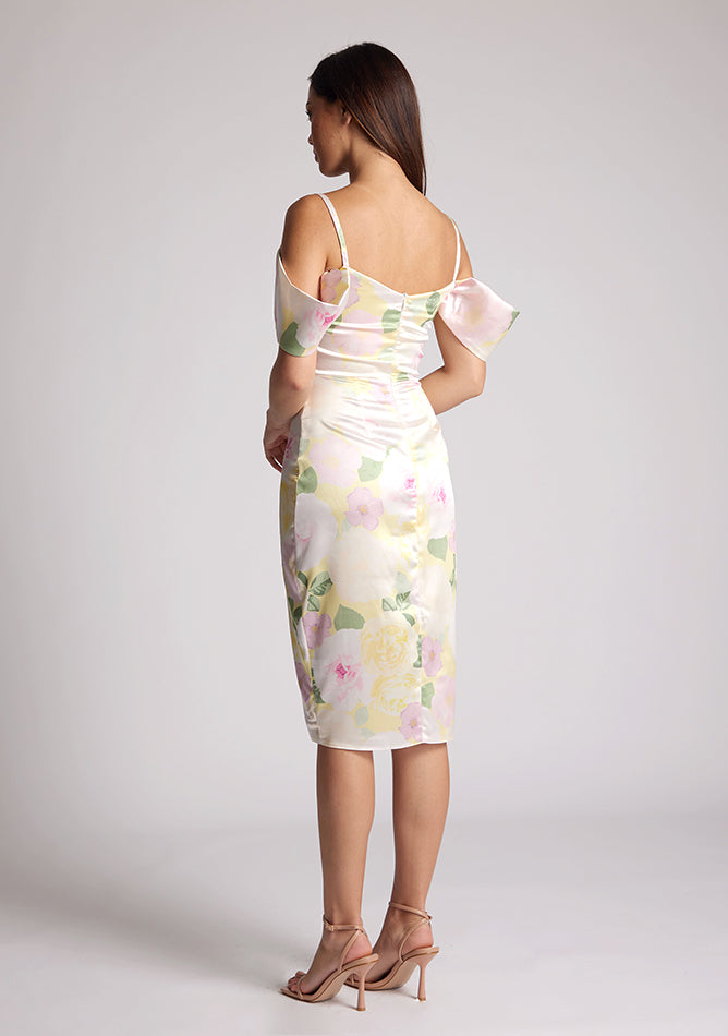 Back quarter image of a model wearing a Floral Print Satin Bardot Midi Dress with a cowl neckline and invisible back zip with thin straps and draped arm bands, a design features Vesper Victoria Floral Print Satin Bardot Midi Dress