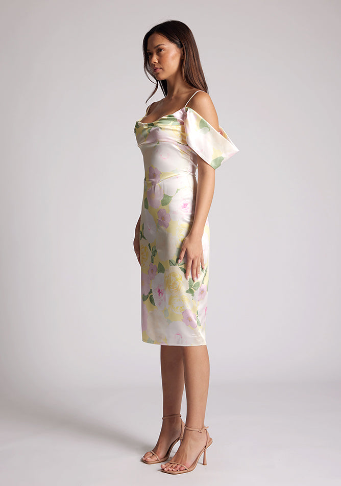 Front quarter image of a model wearing a Floral Print Satin Bardot Midi Dress with a cowl neckline and invisible back zip with thin straps and draped arm bands, a design features Vesper Victoria Floral Print Satin Bardot Midi Dress