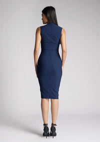 Back image of a model wearing a navy midi dress, featuring a square neck line and high back. The dress featured is the Vesper Wintar navy midi dress