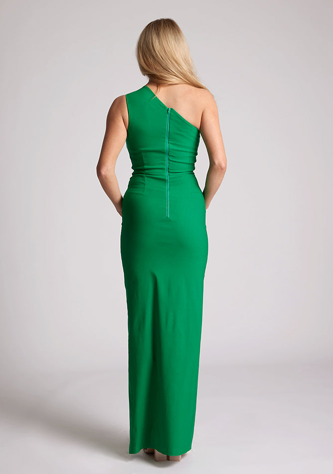 Back image of a model wearing a emerald maxi dress, featuring a one shoulder with a cut out design. The dress featured is the Vesper Wren emerald maxi dress