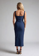 Back image of the model wearing a Navy Bodycon Midaxi Dress with a square neckline with wide straps, and a front skirt split, a design features Vesper Abbie Navy Bodycon Midaxi Dress