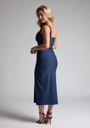 Quarter back image of the model wearing a Navy Bodycon Midaxi Dress with a square neckline with wide straps, and a front skirt split, a design features Vesper Abbie Navy Bodycon Midaxi Dress