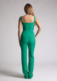 Back image of a model wearing an emerald green jumpsuit, featuring a sweetheart neckline, wide straps and a keyhole cut-out detail under bust, this style is finished with a wide leg. The style featured is Vesper Collette Emerald Jumpsuit.