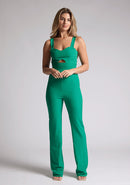 Front image of a model wearing an emerald green jumpsuit, featuring a sweetheart neckline, wide straps and a keyhole cut-out detail under bust, this style is finished with a wide leg. The style featured is Vesper Collette Emerald Jumpsuit.