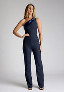 Front image of the model wearing a navy Jumpsuit with an asymmetric neckline, with a contrast satin band and wide leg finish a design features Vesper Georgie Navy Jumpsuit