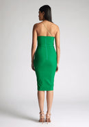 Back image of the model wearing an emerald midi dress with a asymmetrical neckline with one strap, and a bodycon silhouette, the style featured is Vesper Leslie Emerald Midi Dress