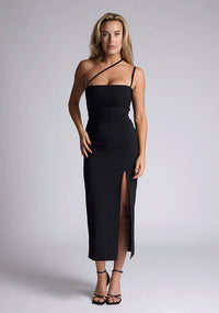 Front image of the model wearing a black bodycon midaxi dress with a straight neckline, cross strap detail, and front skirt split. The design featured is the Vesper Abigail Black Cross Strap Midaxi Dress