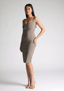 Front quarter image of a model wearing a taupe midi bodycon dress with a soft v-neckline, bodycon fit, wide straps and centre-back zip. The design featured is the Vesper Azzura Tuape Midi Bodycon Dress
