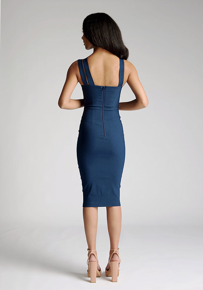Back image of a model wearing a navy midi dress with a straight neckline and asymmetric straps. The design featured is the Vesper Bianca Navy Midi Dress