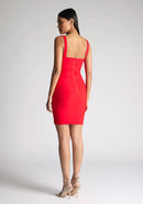 Back quarter image of model wearing a red square neck mini dress with a chic square neckline and figure-hugging bodycon design. The dress featured is the Vesper Carly Red Square Neck Mini Dress