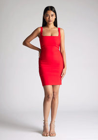 Front image of model wearing a red square neck mini dress with a chic square neckline and figure-hugging bodycon design. The dress featured is the Vesper Carly Red Square Neck Mini Dress