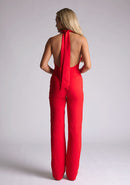 Back image of blonde model red collar detail jumpsuit with a strapless design and halter neck, this jumpsuit offers both comfort and sophistication. The designed featured is the Vesper Cindy Red Collar Detail Jumpsuit