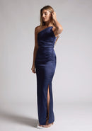 Front quarter image of a model wearing a navy satin maxi dress with a asymmetric neckline, one shoulder detail, side waist cut-out and a side skirt split. The design featured is the Vesper Esme Navy Satin  Maxi Dress