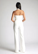 Back image of a  model wearing a ivory waistcoat with a chic, sophisticated and sleeveless halter-neck waistcoat top. The design featured is the Vesper Eve Ivory Waistcoat paired  with Vesper Connie Ivory Wide Leg Trousers