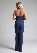 Back image of a  model wearing a nany waistcoat with a chic, sophisticated and sleeveless halter-neck waistcoat top. The design featured is the Vesper Eve Navy Waistcoat paired with Vesper Connie Navy Wide Leg Trousers