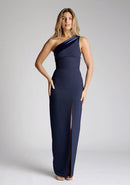 Front image of model wearing a One-Shoulder Navy Maxi Dress with an asymmetric neckline and a daring thigh-high leg slit, and a front cut-out. The design features the Vesper Fliss One Shoulder Navy Maxi Dress.