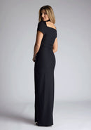 Back quarter image of a blonde model wearing a Black Maxi Dress with a high-neck with a subtle cut-out detail, and a front skirt split, a design features Vesper Josephine Black Maxi Dress